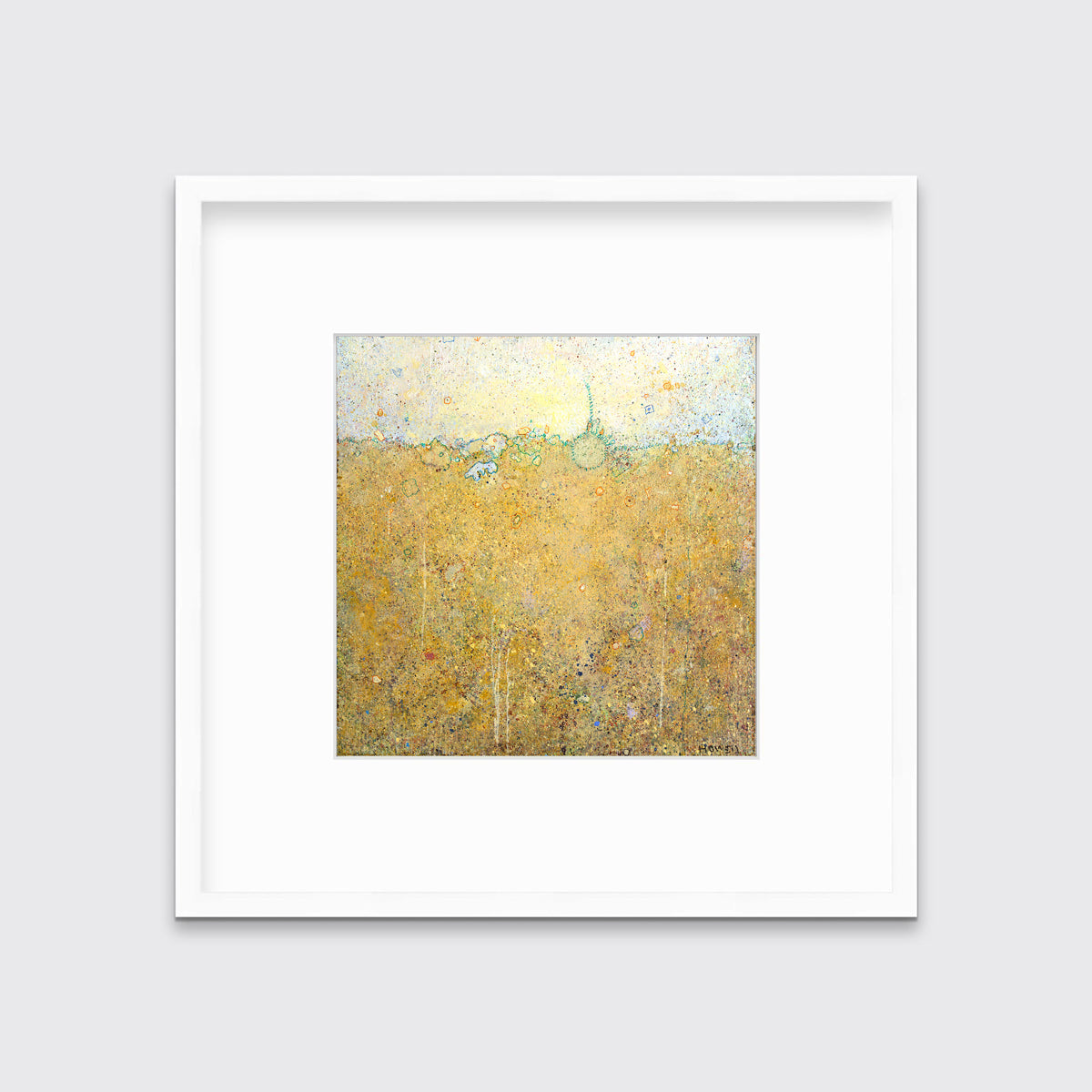 A yellow abstract landscape print in a white frame with a mat hangs on a white wall.