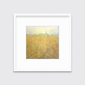 A yellow abstract landscape print in a white frame with a mat hangs on a white wall.