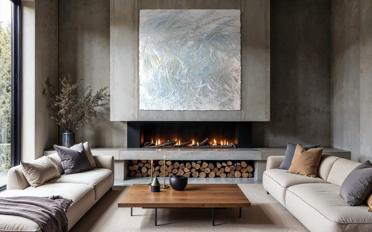 Modern living room with a fireplace and an original abstract painting by Teo Guererra, and comfortable seating.