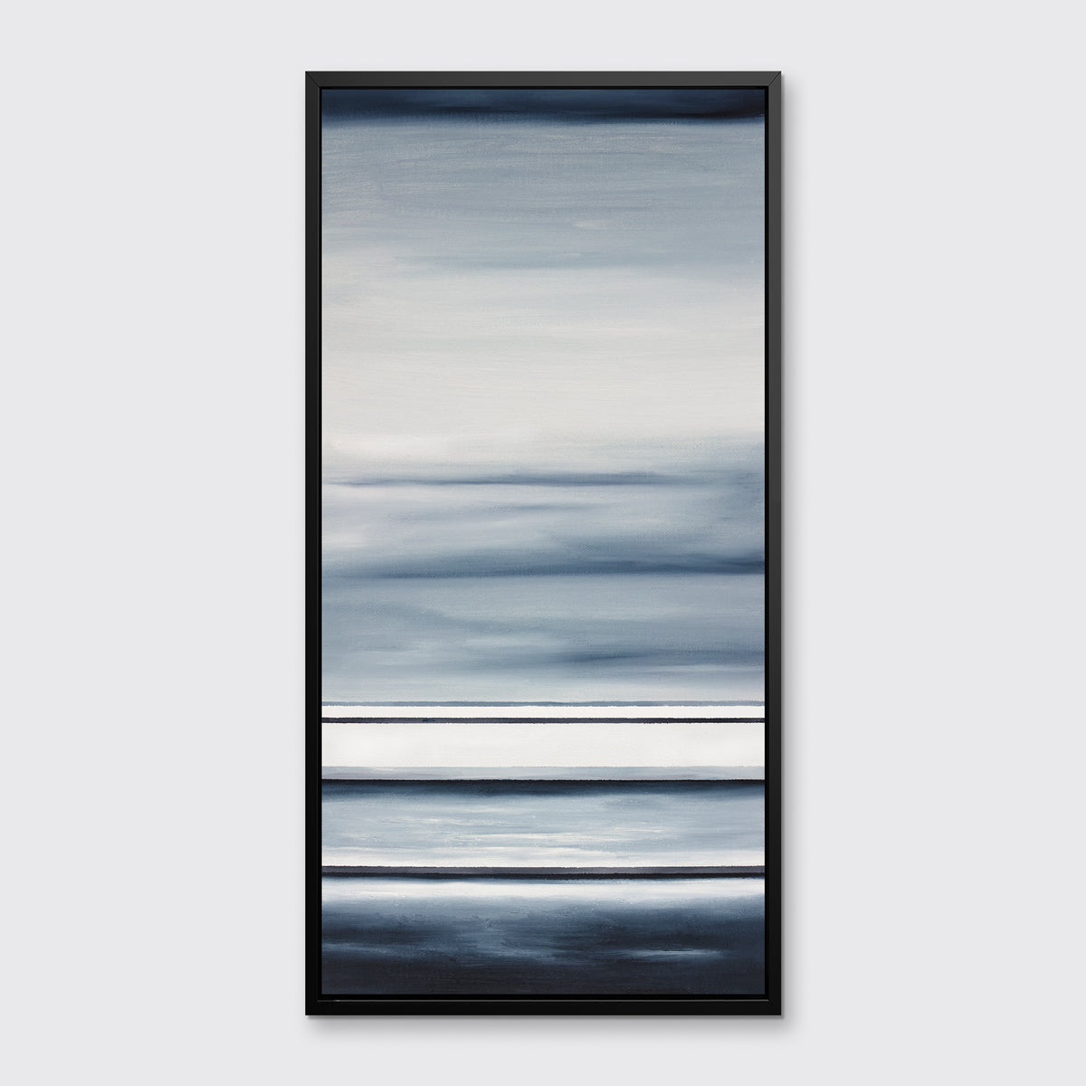 Different sized bands of hues of blue and white in a black floater frame on a wall.