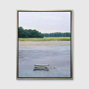 A limited edition landscape print framed in a silver frame hangs on a white wall. 