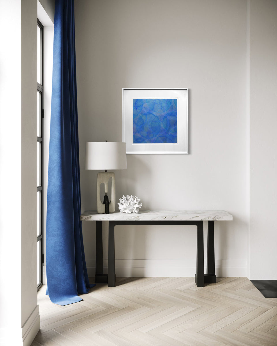 Modern interior with a console table, lamp, and abstract painting on a wall.