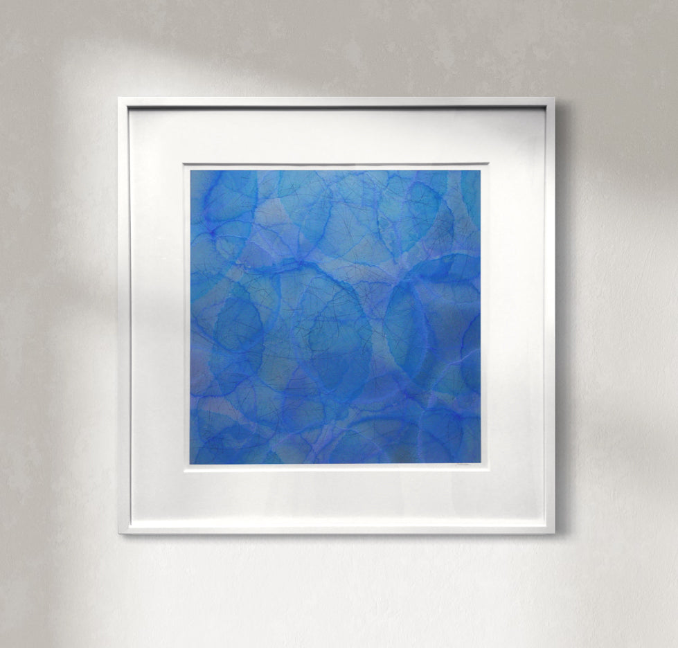 A square-shaped, framed abstract artwork featuring a geometric pattern of blue circles