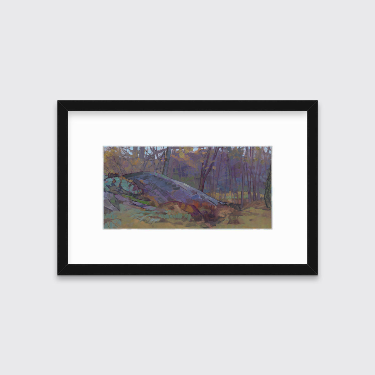 A muted multicolored abstract landscape print in a black frame with a mat hangs on a white wall.