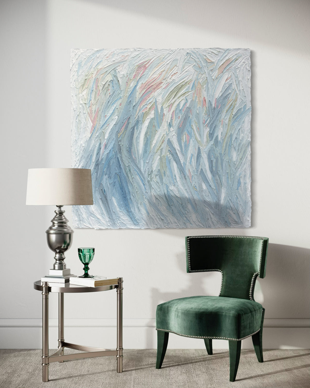 Modern interior with a green chair, side table, and abstract painting on a white wall.