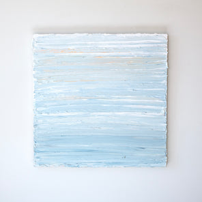 An abstract painting with thick impasto brushstrokes of blue, white, teal, and hints of orange paint is hung on a gallery wall.