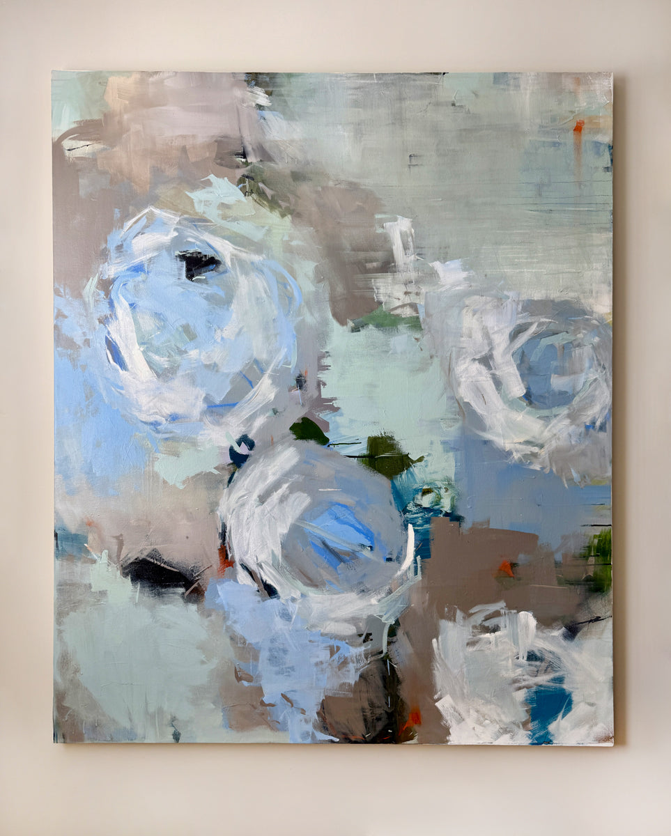 Abstract painting with blue and white elements on a beige wall
