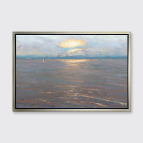 A coastal seascape print in a silver floater frame hangs on a white wall.