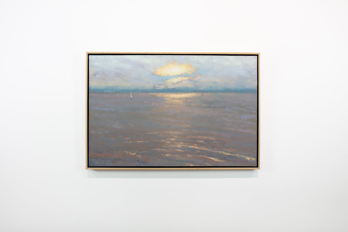 A lavender, orange, yellow and light blue coastal seascape painting by Molly Doe Wensberg hangs in a light wood floater frame on a white wall.