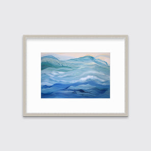 A blue, teal and light orange abstract print in a silver frame with a mat hangs on a white wall.