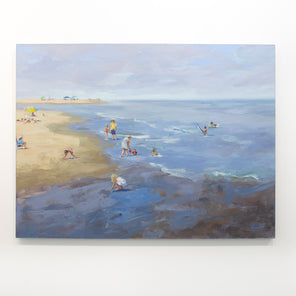 A light blue painting of a beach shoreline hangs on a white wall. 