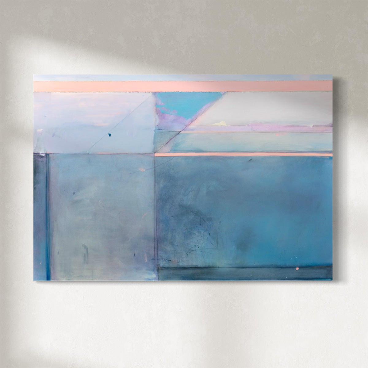 A blue and pink abstract painting hangs on a white wall. 