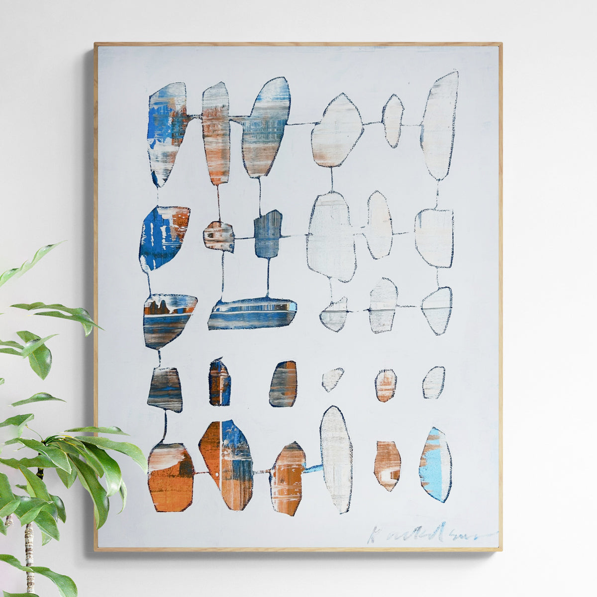 Abstract art piece with geometric shapes on a light gray background, framed in light wood frame. 