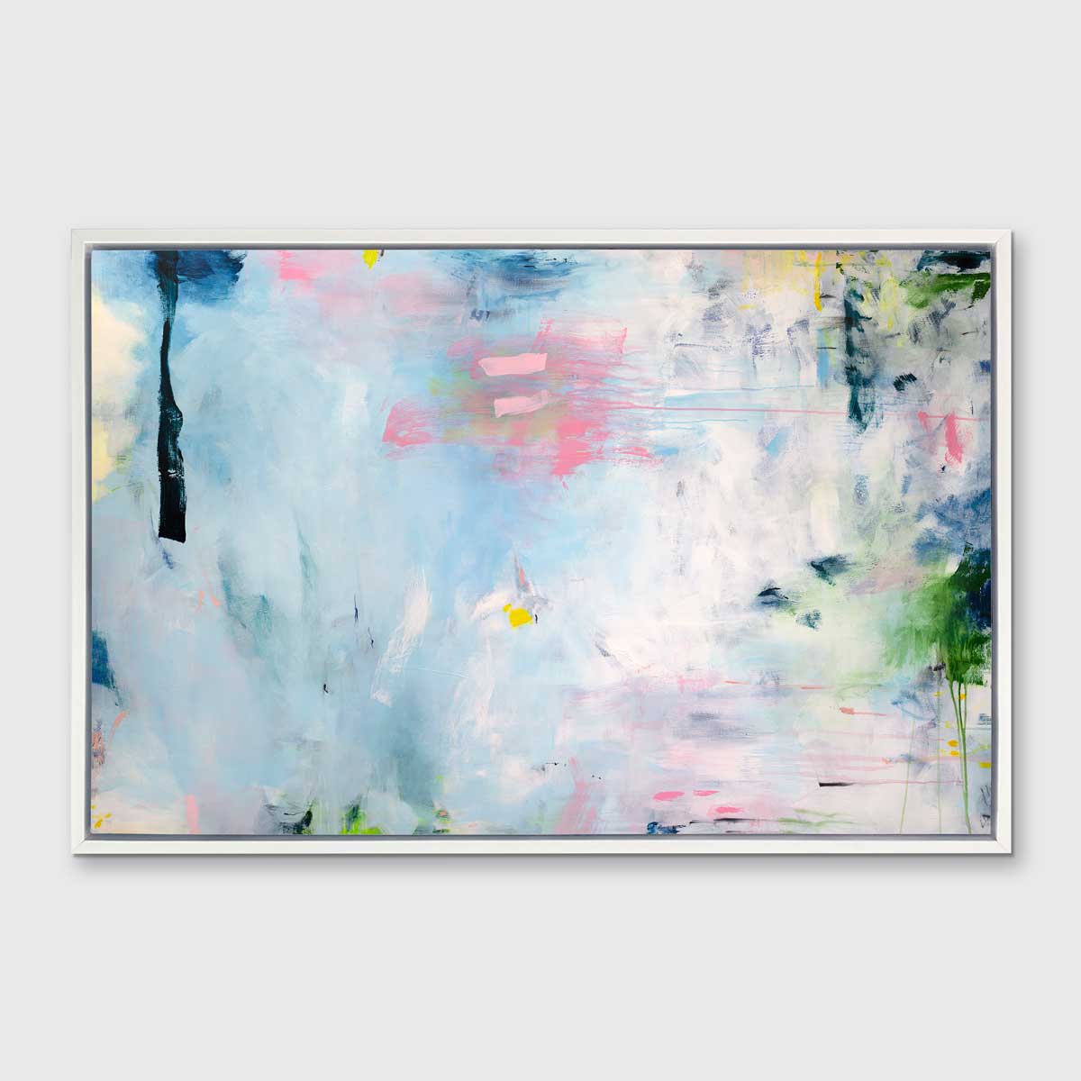 A blue, pink and white abstract print in a white floater frame hangs on a white wall.