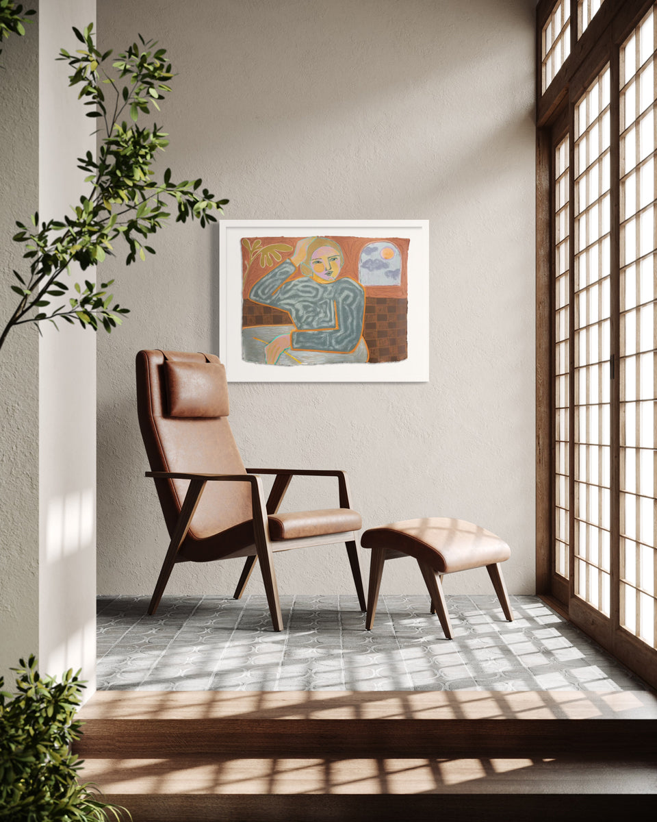 A framed yellow, orange, and grey abstracted figure painting hangs on a textured beige walls next to floor-to-ceiling sliding doors and above a reclining leather chair and footstool. 