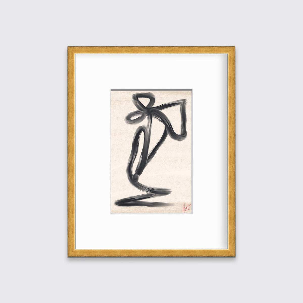 An abstract black and beige art print framed in a gold print hangs on a light grey wall. 