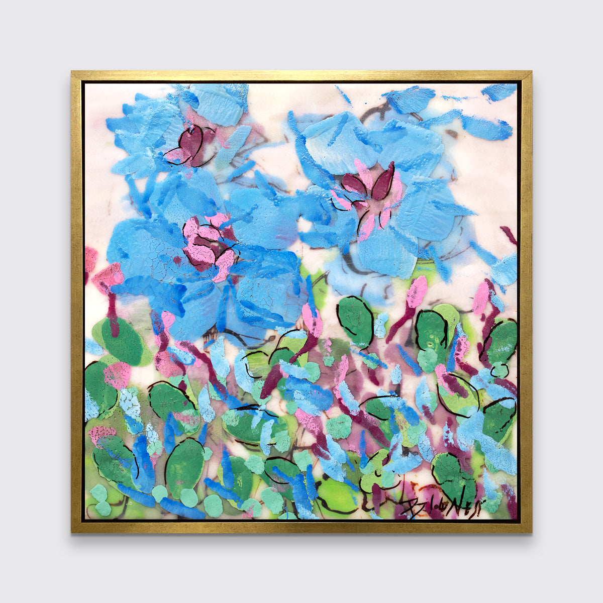 A blue, pink, green and white abstract floral print in a gold floater frame hangs on a white wall.