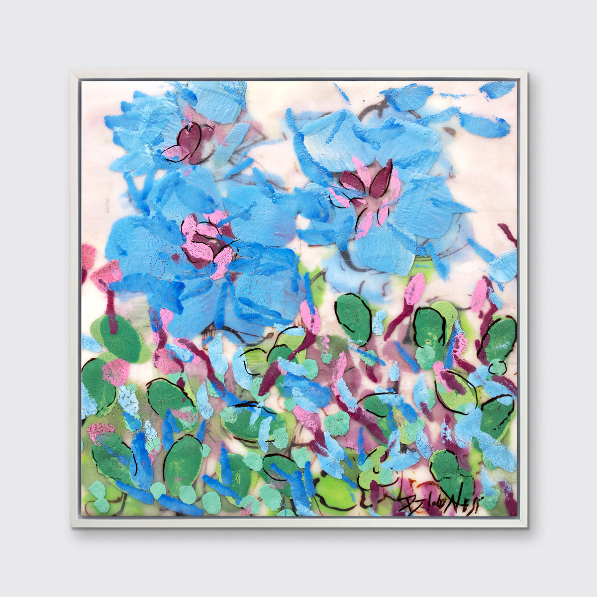 A blue, pink, green and white abstract floral print in a white floater frame hangs on a white wall.