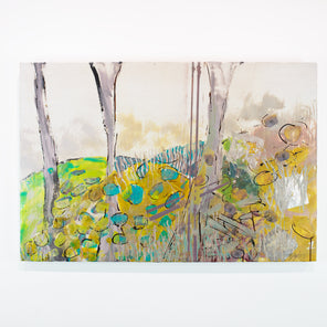 A yellow and blue abstract painting hangs on a white wall.