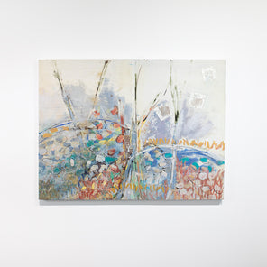 A multicolored abstract painting hangs on a white wall. 