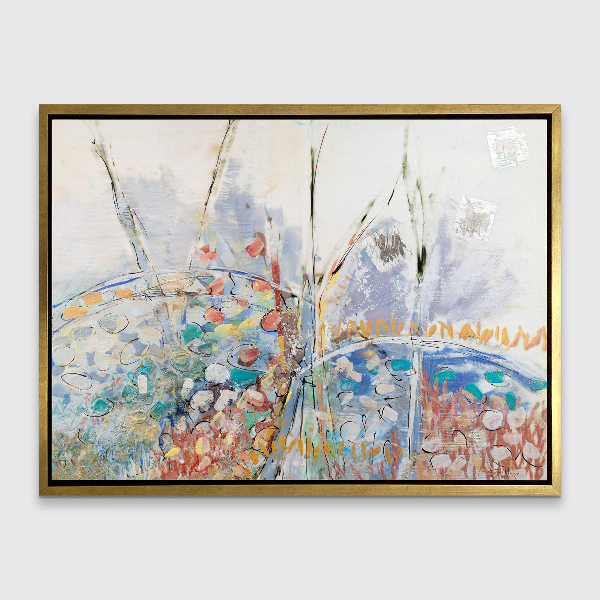 A multicolored abstract floral print in a gold floater frame hangs on a white wall.