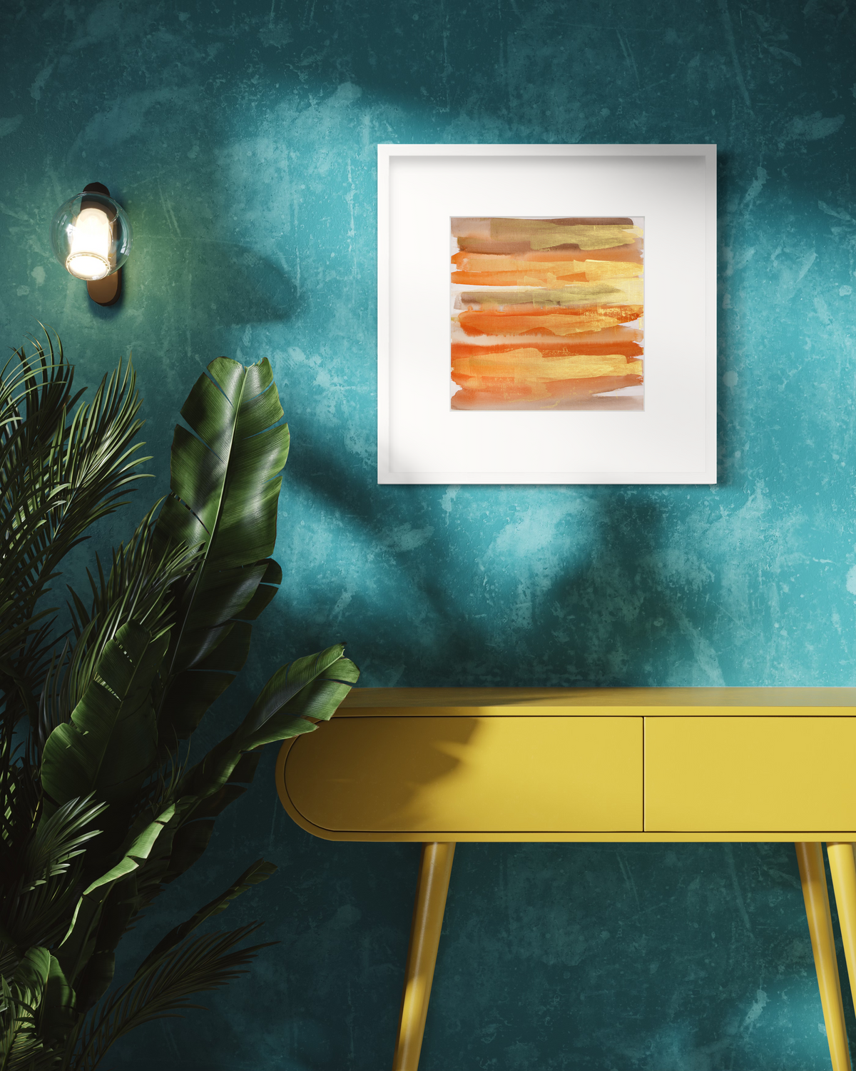 A gold, orange and light brown abstract print in a white frame with a mat hangs on a teal wall above a yellow modern console table and a large potted floor plant.