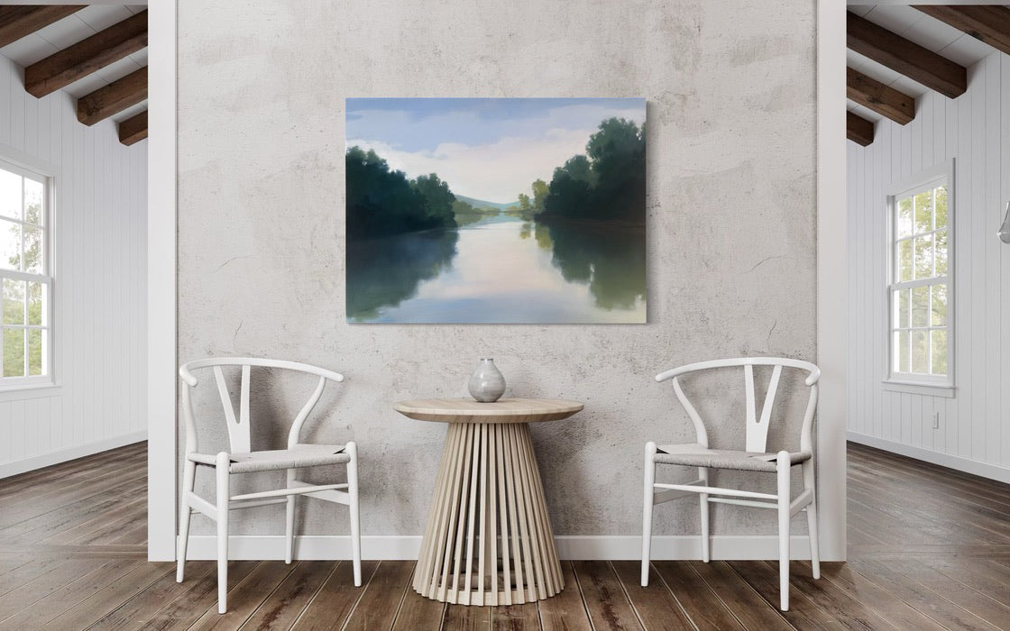 Modern interior with white chairs, a round table, and a painting of a landscape on the wall.
