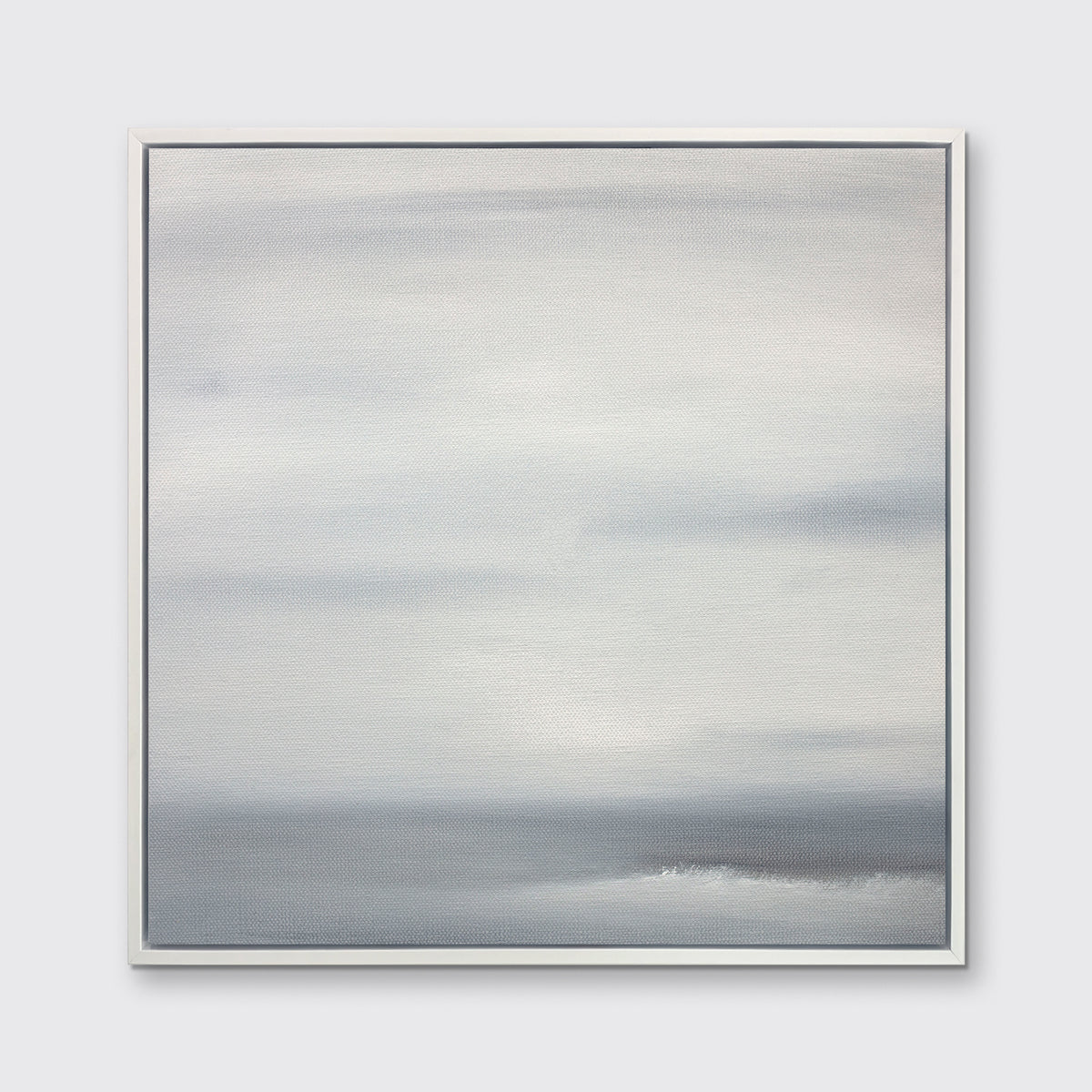 A tonal grey print in a white floater frame hangs on a white wall.
