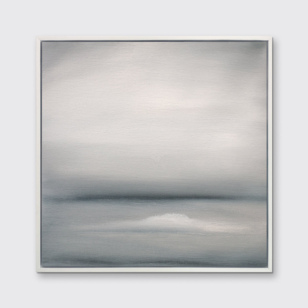 A tonal grey abstract print in a white floater frame hangs on a white wall.