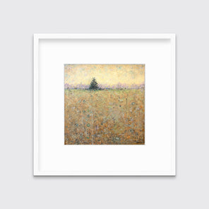 A green, orange and yellow abstract landscape print in a white frame with a mat hangs on a white wall.