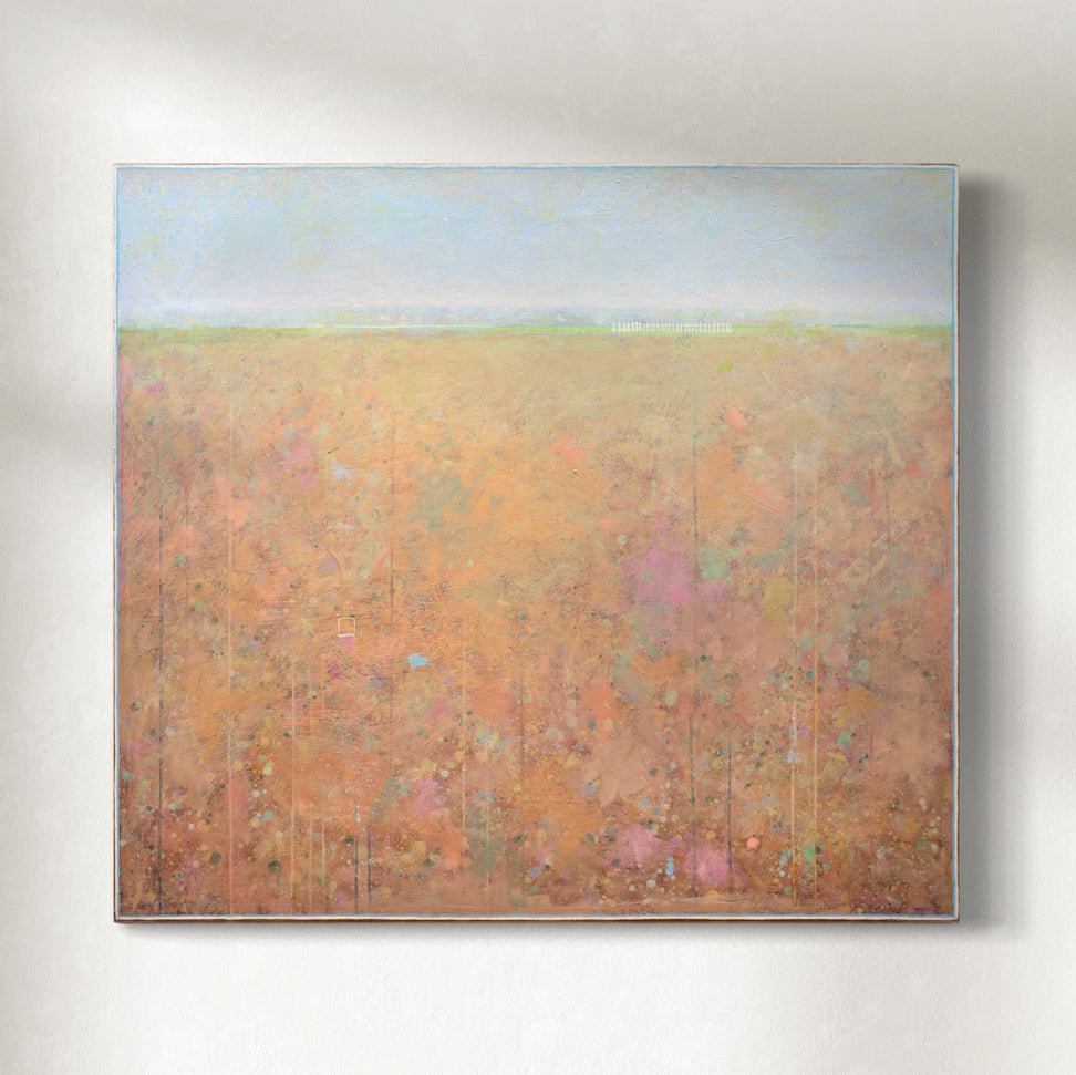Abstract landscape painting with a high horizon line and soft tones of peach, orange, yellow bottom and blue top hanging on a sunlight wall.