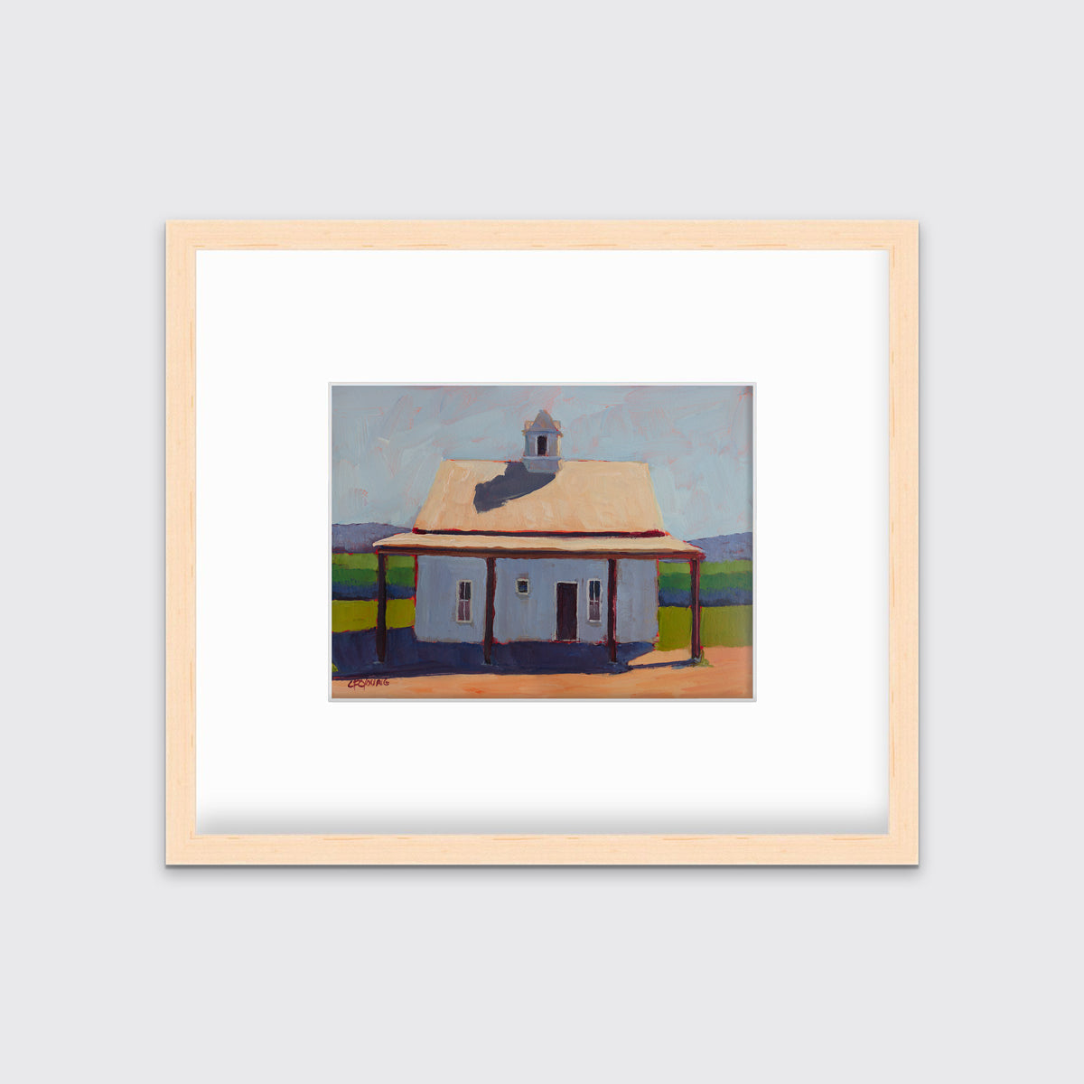 A contemporary house print by Carol Young in a natural wood frame with a mat hangs on a white wall.