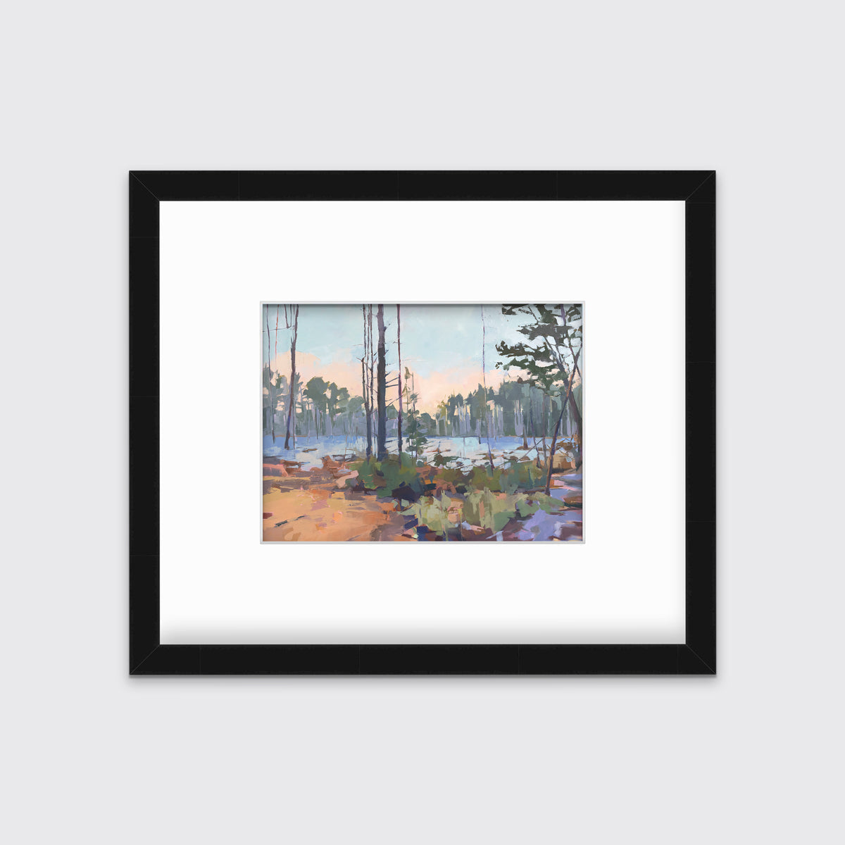 A light blue, green, brown and purple abstract landscape print in a black frame with a mat hangs on a white wall.