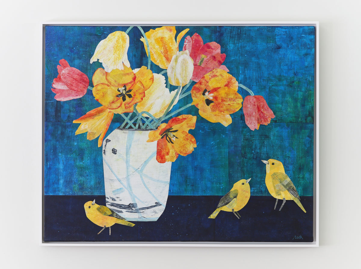 A framed square collage featuring a white vase filled with yellow, orange, and red flowers against a textured blue background, with three small yellow birds on a dark surface below.