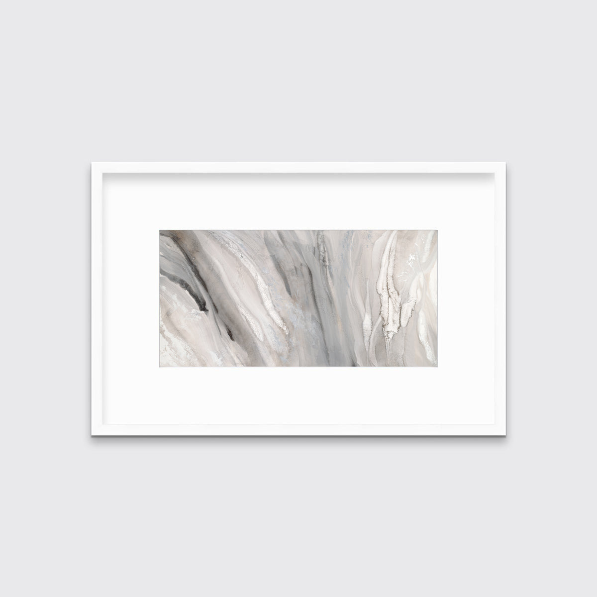 A beige, white and gold abstract print in a white frame with a mat hangs on a white wall.