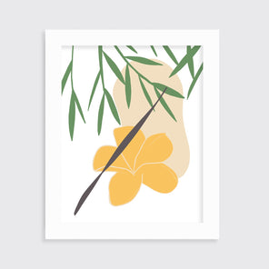 A green and yellow abstract botanical art print framed in an unmatted white frame hangs on a light wall.