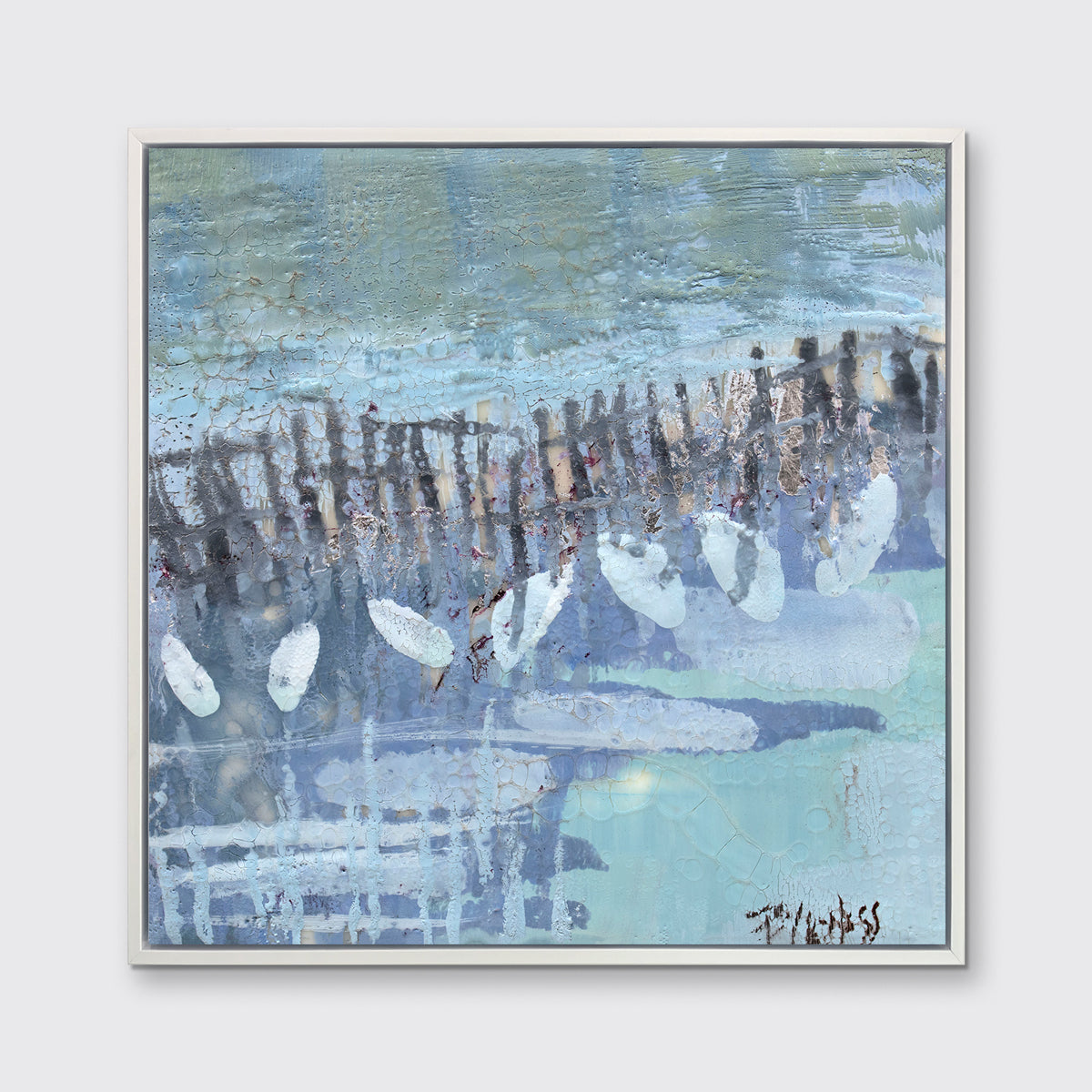A blue, lavender and olive green abstract print in a white floater frame hangs on a white wall.
