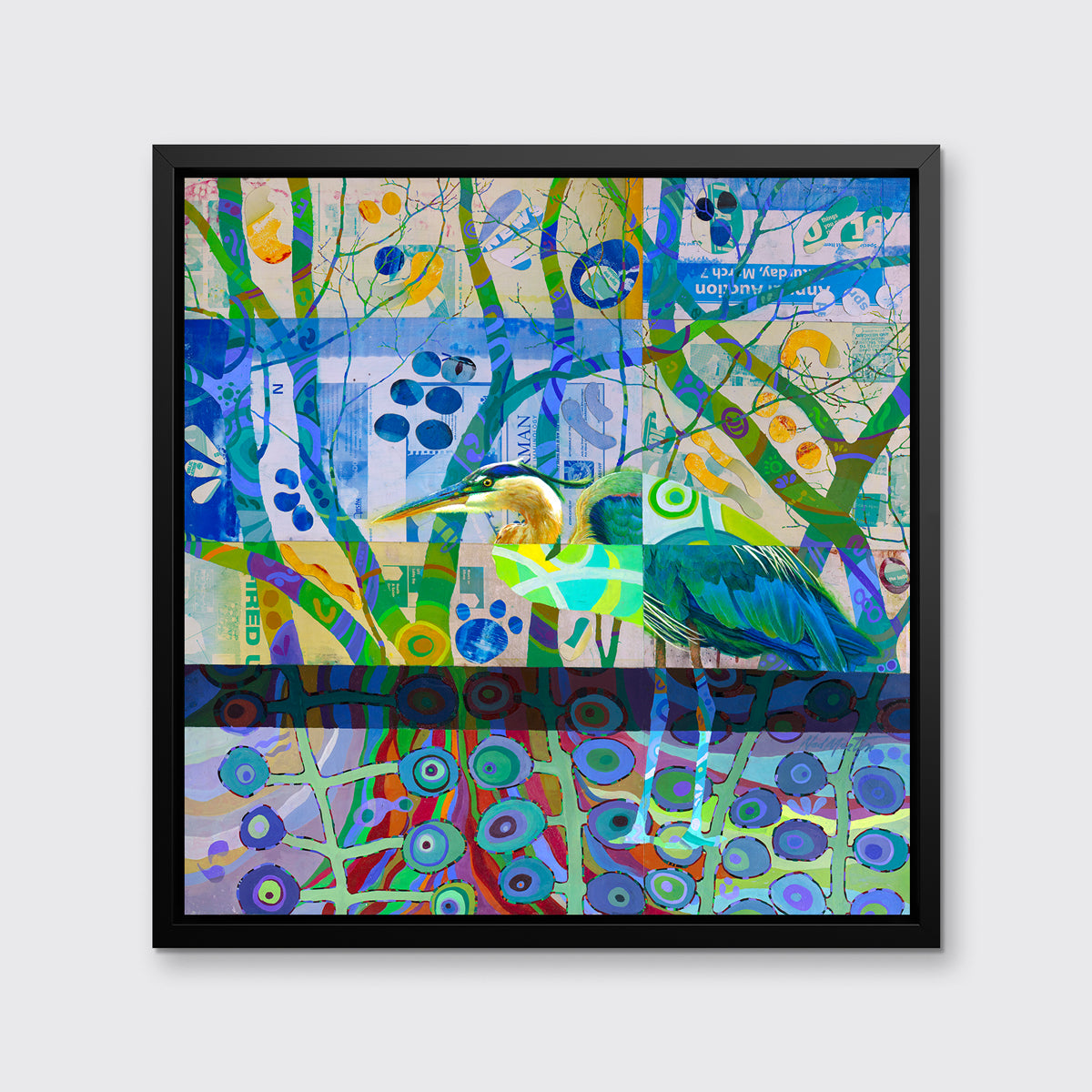 A multicolored abstract print with a blue heron in a black floater frame hangs on a white wall.