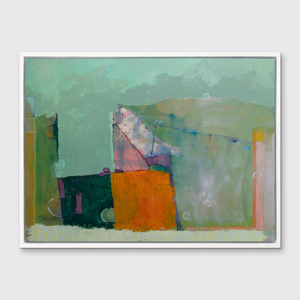 A green, orange and purple abstract print in a white floater frame hangs on a white wall.