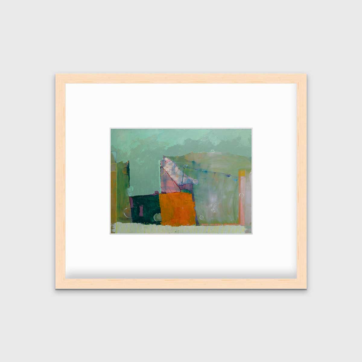 A green abstract print by Christine Averill-Green in a natural wood frame with a mat hangs on a white wall.