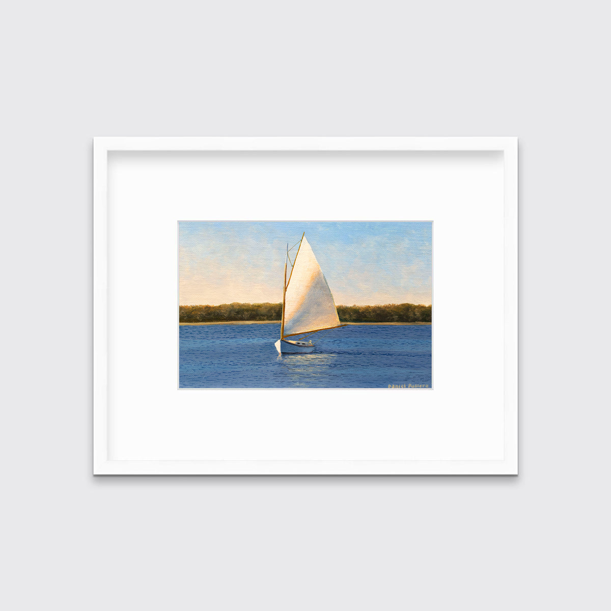 A blue and beige contemporary seascape print with a sailboat in a white frame with a mat hangs on a white wall.