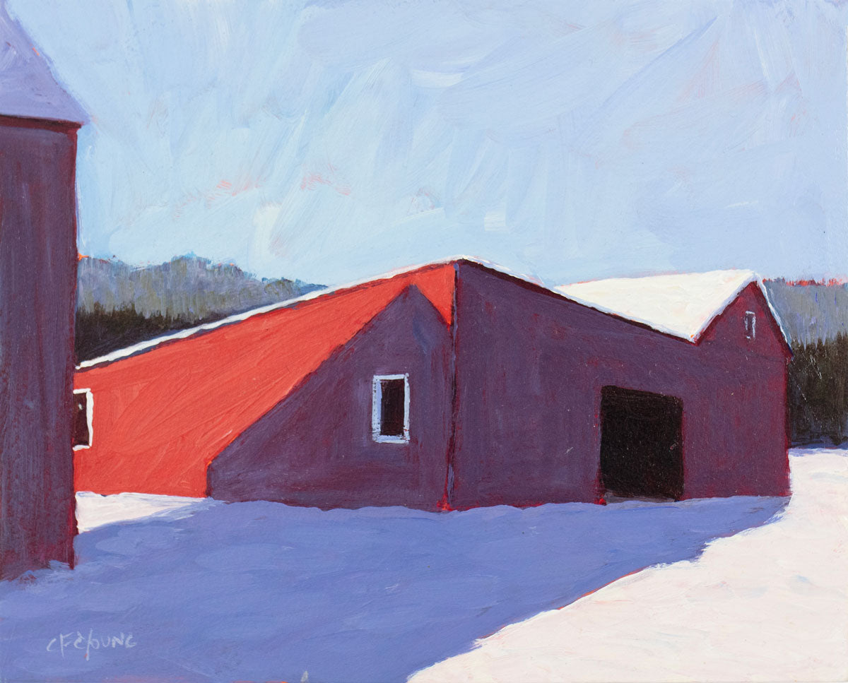A blue painting of a red barn in the snow by Carol Young. 