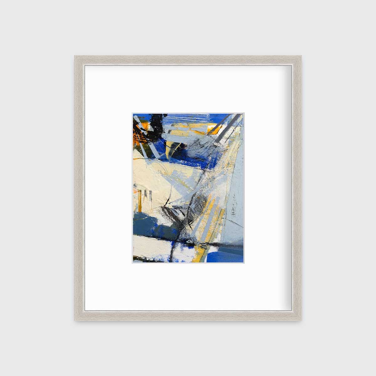 A blue, white, yellow and black abstract print in a silver frame with a mat hangs on a white wall.