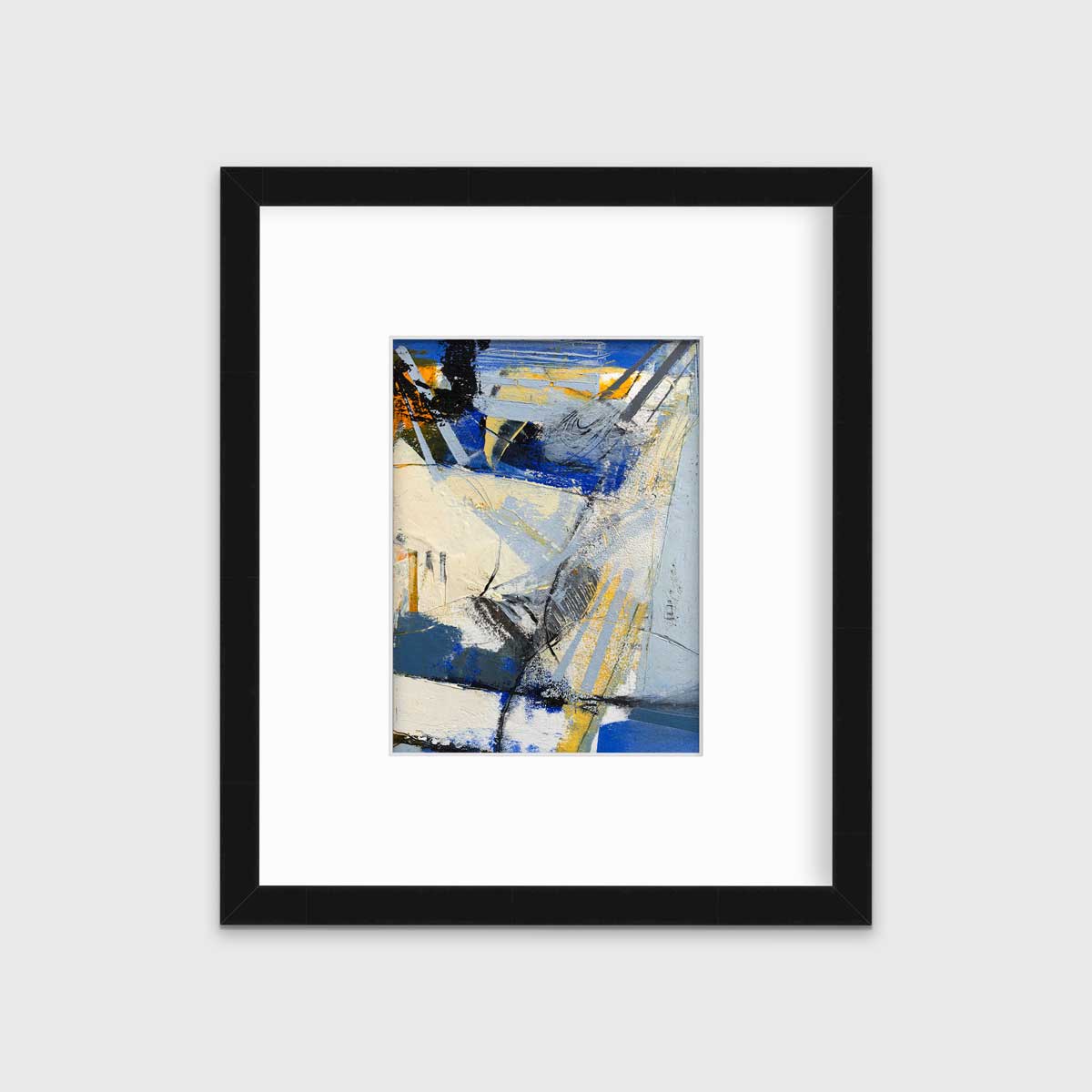 A blue, white, yellow and black abstract print in a black frame with a mat hangs on a white wall.