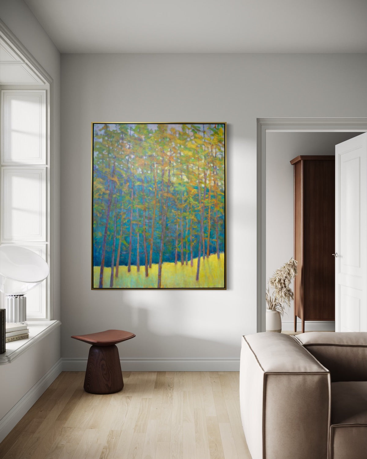 Modern interior with a colorful abstract painting on a wall, a beige sofa, and a small table.