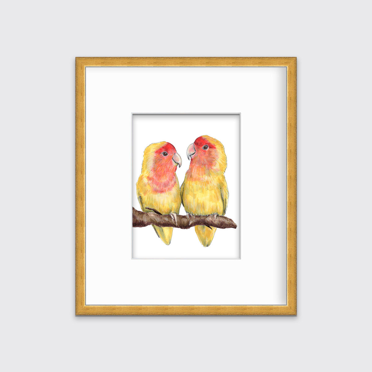 An illustration of two yellow birds sitting on a branch framed in a gold frame hangs on a white wall. 