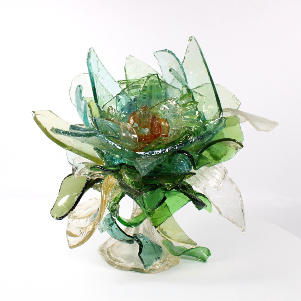 Artistic glass sculpture resembling a flower on a white background.