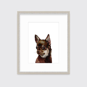 An illustration of a Chihuahua dog framed in a silver frame hangs on a white wall.