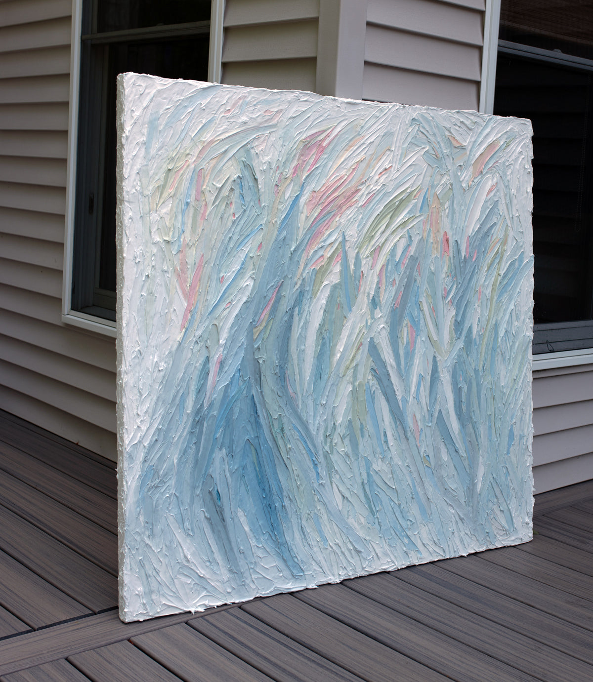 Abstract painting on a wooden deck