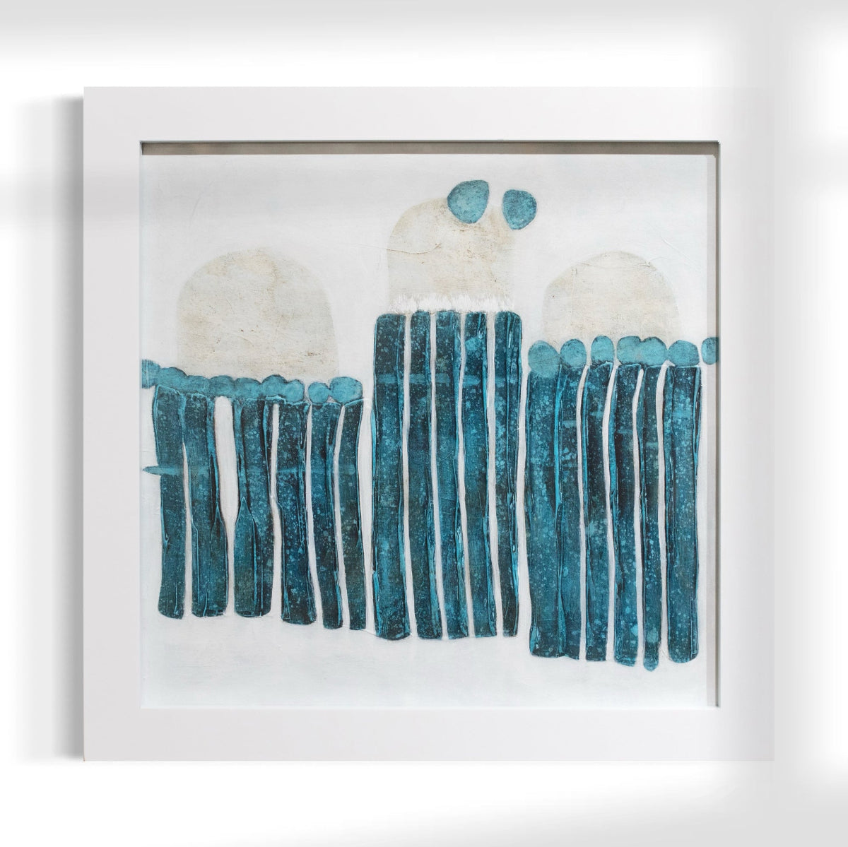 Framed abstract artwork with blue and white elements on a white background